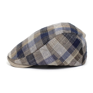 Detailed texture of cotton plaid flat cap showing weave pattern and brim stitch
