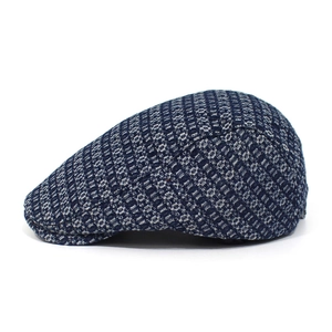 Macro shot of dark blue jacquard denim fabric texture on a vintage flat cap