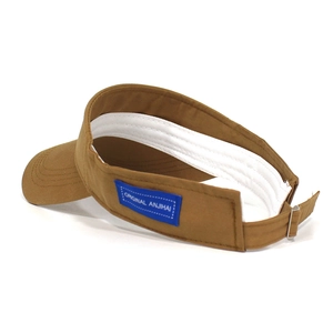 Detailed side view of brown cotton sun visor with navy blue tag and adjustable metal buckle