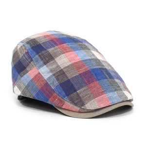 Detailed close-up of colorful plaid cotton newsboy cap with premium stitching and texture