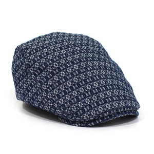 Detail view of cotton jacquard denim flat cap featuring dark blue geometric texture