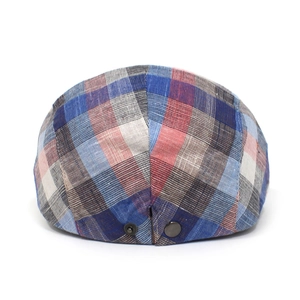 Close-up of multicolor plaid flat cap featuring breathable cotton and metal snap buckles