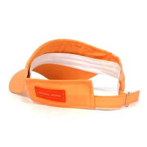 Detail view of orange sun visor showing inner sweatband and adjustable metal buckle