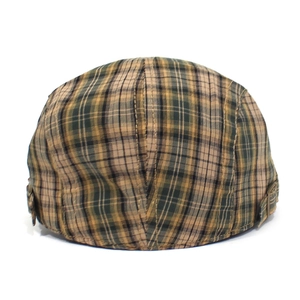 Detail of the vintage plaid flat cap with a bronze metal buckle on the side panel