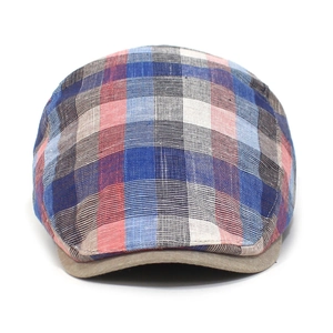 Detail of breathable plaid cotton fabric and structured brim on a classic flat cap