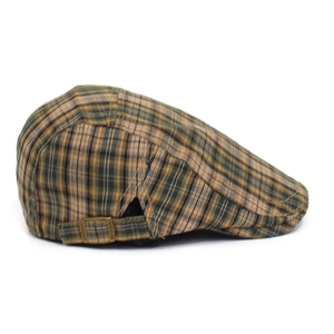 Detail view of newsboy cap featuring classic plaid pattern and side bronze metal buckle