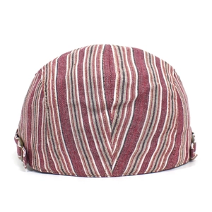 Detail of vintage striped ivy cap showing side metal buckle and breathable fabric texture