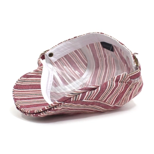 Macro view of adjustable back strap and inner lining on striped cotton newsboy cap