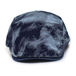 Detailed close-up of dark blue camouflage washed denim beret with fabric texture