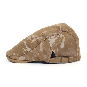 Detail view of brown cotton ivy cap featuring textured jacquard and bronze metal buckle