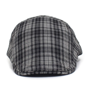 Detail of gray plaid pattern on a vintage flat cap showing premium fabric texture
