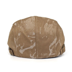 Detailed close-up of brown ivy cap with tie-dye print and adjustable metal back buckle