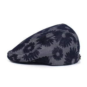 Close-up of floral jacquard fabric and metal adjustment buckle on the cotton beret