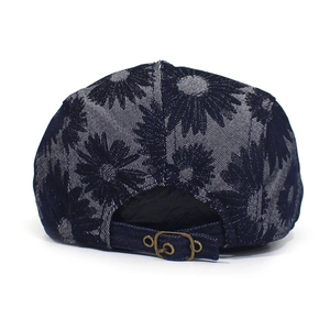 Rear view of navy blue cotton beret with white daisy prints and metal adjustment buckle