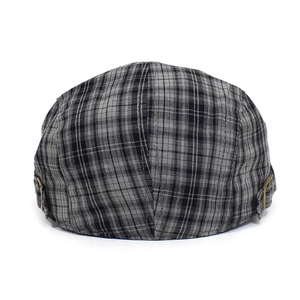 Detailed view of grey plaid newsboy cap with textured fabric and side metal buckle