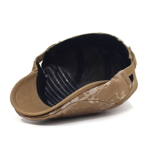 Detailed interior of a beige flat cap with camo pattern and inner sweatband showing structure