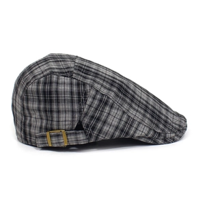Detailed side view of classic plaid flat cap with a metallic adjustment buckle