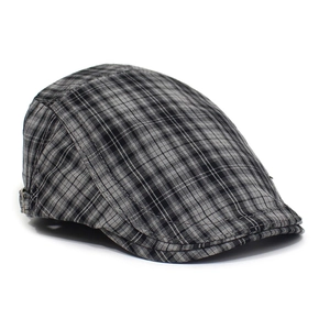 Detail of classic black and white plaid beret cap with metal side adjustment buckle
