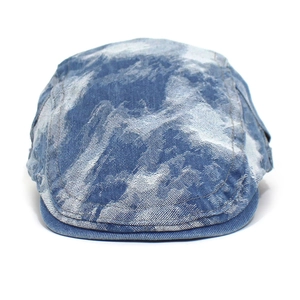 Detail shot of vintage washed denim beret featuring unique white tie-dye ink patterns