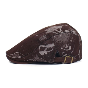 Detail view of printed flat cap featuring abstract patterns and adjustable metal buckle