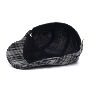 Close-up of the black and grey plaid newsboy cap with breathable inner lining and sweatband