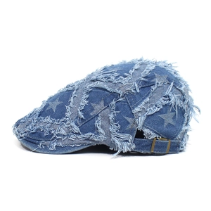 Detail der blauen Denim-Schirmmütze mit weißen Sternmustern und ausgefranstem Vintage-Look