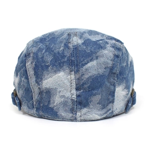 Detail of blue washed denim beret featuring adjustable metal buckle on the back