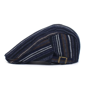 Detail of adjustable metal side buckle on striped cotton beret for custom fit