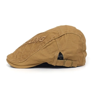 Detail of khaki cotton flat cap with FLING embroidery, quilted texture and metal buckle