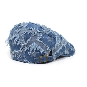 Detail der blauen Denim Schiebermütze mit Sternmuster und verstellbarer Bronzeschnalle