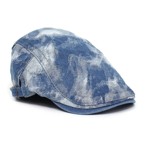 Close-up of washed denim newsboy cap featuring side metal adjustment buckles and stitching