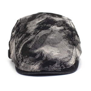 Close-up of washed denim beret featuring black and white camo pattern with dark brim