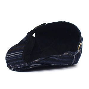 Detail view of cotton striped flat cap with side adjustable metal buckle closure