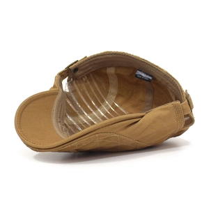 Detail view of khaki cotton canvas flat cap featuring quilted texture and metal buckle