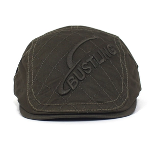 Detail of BUSTLING letter embroidery on quilted cotton canvas beret with diamond texture