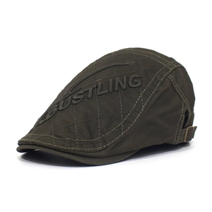 Detail of olive green flat cap featuring 3D embossed BUSTLING lettering and quilted fabric