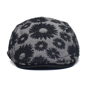 Close-up of grey cotton ivy cap featuring black daisy print and contrasting black brim