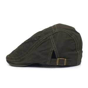 Detail of olive green cotton beret with side embroidery and metallic adjustment buckle
