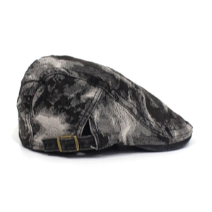 Detail view of washed denim beret featuring adjustable bronze buckle and vintage texture
