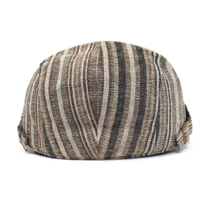 Detail of striped cotton beret cap featuring adjustable metal buckles on the side