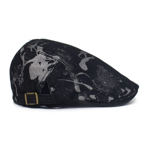 Detail view of cotton flat cap with abstract print and vintage metal side buckle