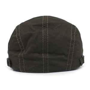 Detail view of cotton flat cap featuring metal side buckles and reinforced stitching