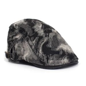 Detail view of washed denim beret featuring ink tie-dye texture and metal buckle adjustment