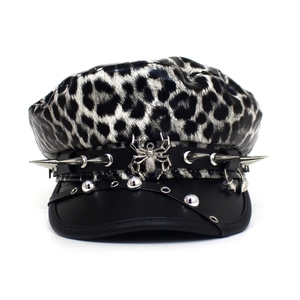 Detail view of leopard print flat top hat with silver metal spider and punk rock spikes