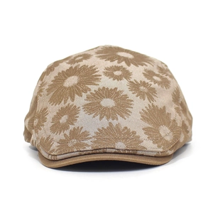 Detailed shot of brown cotton newsboy cap featuring elegant white daisy floral patterns