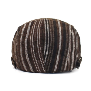 Detail of striped cotton beret cap featuring side metal buckles and corduroy texture