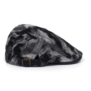 Detail view of adjustable bronze buckle on vintage ink-patterned washed denim ivy cap