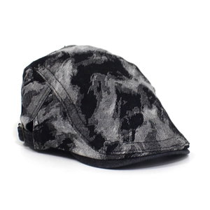 Detail view of washed denim texture and adjustable buckle on vintage newsboy cap