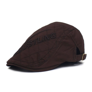 Dark brown quilted duckbill cap with BUSTLING embroidery and adjustable strap