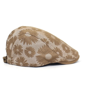 Detailed view of floral jacquard texture and metal adjustment buckle on the beret cap